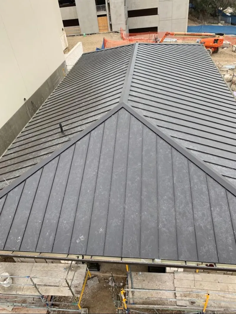 Commercial metal roof construction with crane equipment in Bella Vista